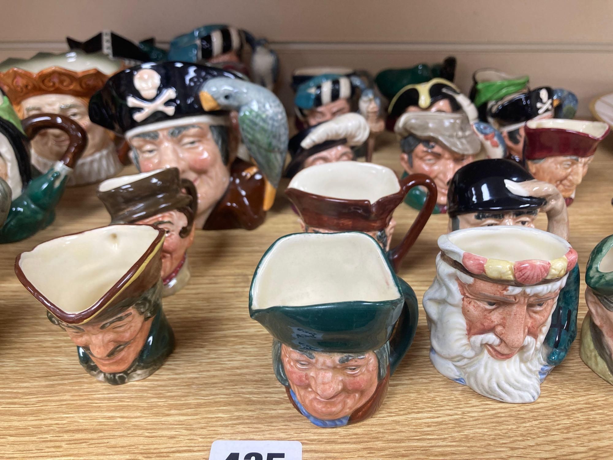 Eight Royal Doulton medium character jugs and seventeen Royal Doulton small character jugs (25)